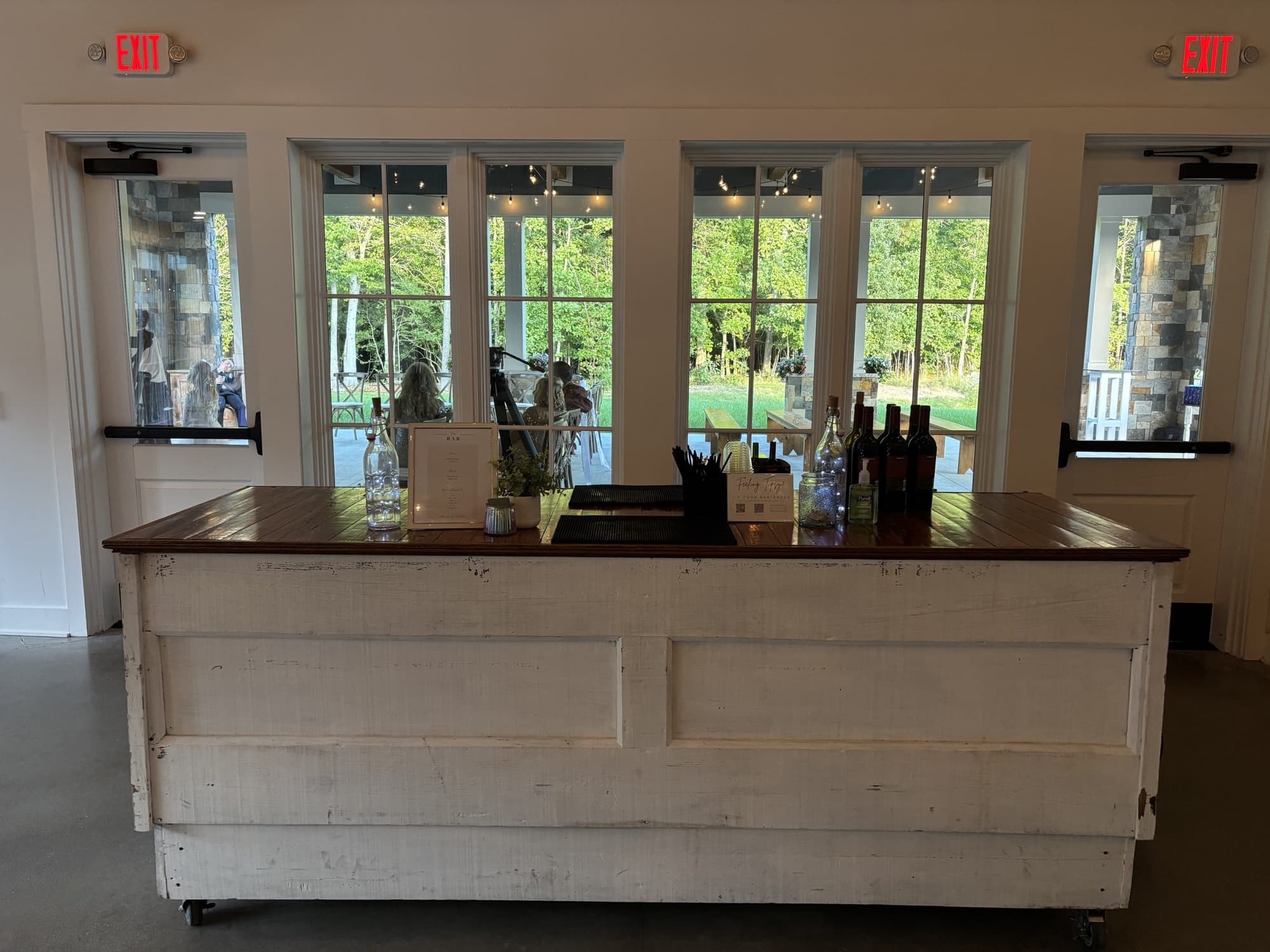 The Pop Up Bar ready for service in a bright venue hall, with garden doors behind it.